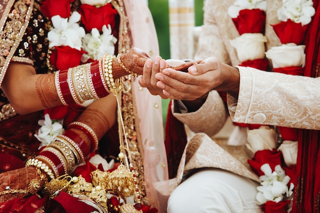 Hands Of Indian Bride And Groom Intertwined Together Making