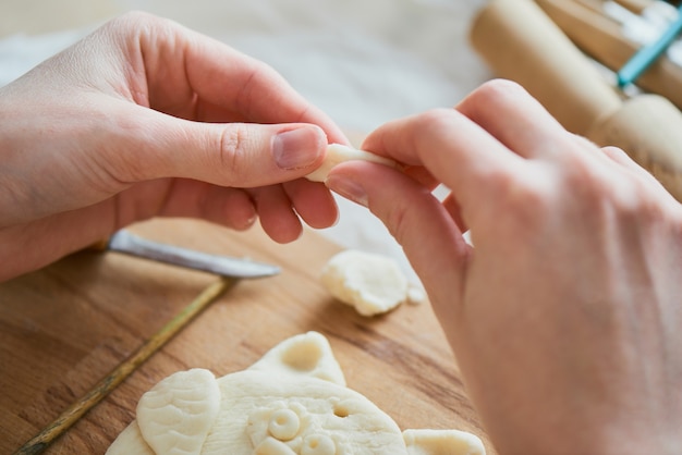 Premium Photo | Hands making a hand made product made from dough