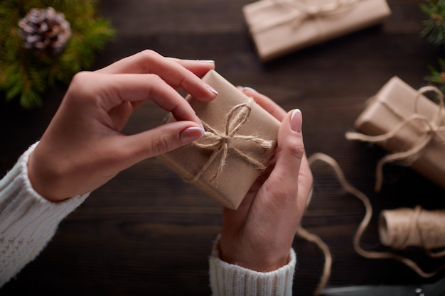 Free Photo Hands tying the knot of string of gift packages