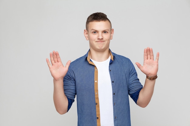 Premium Photo | Hands up young boy wearing white tshirt and blue shirt ...