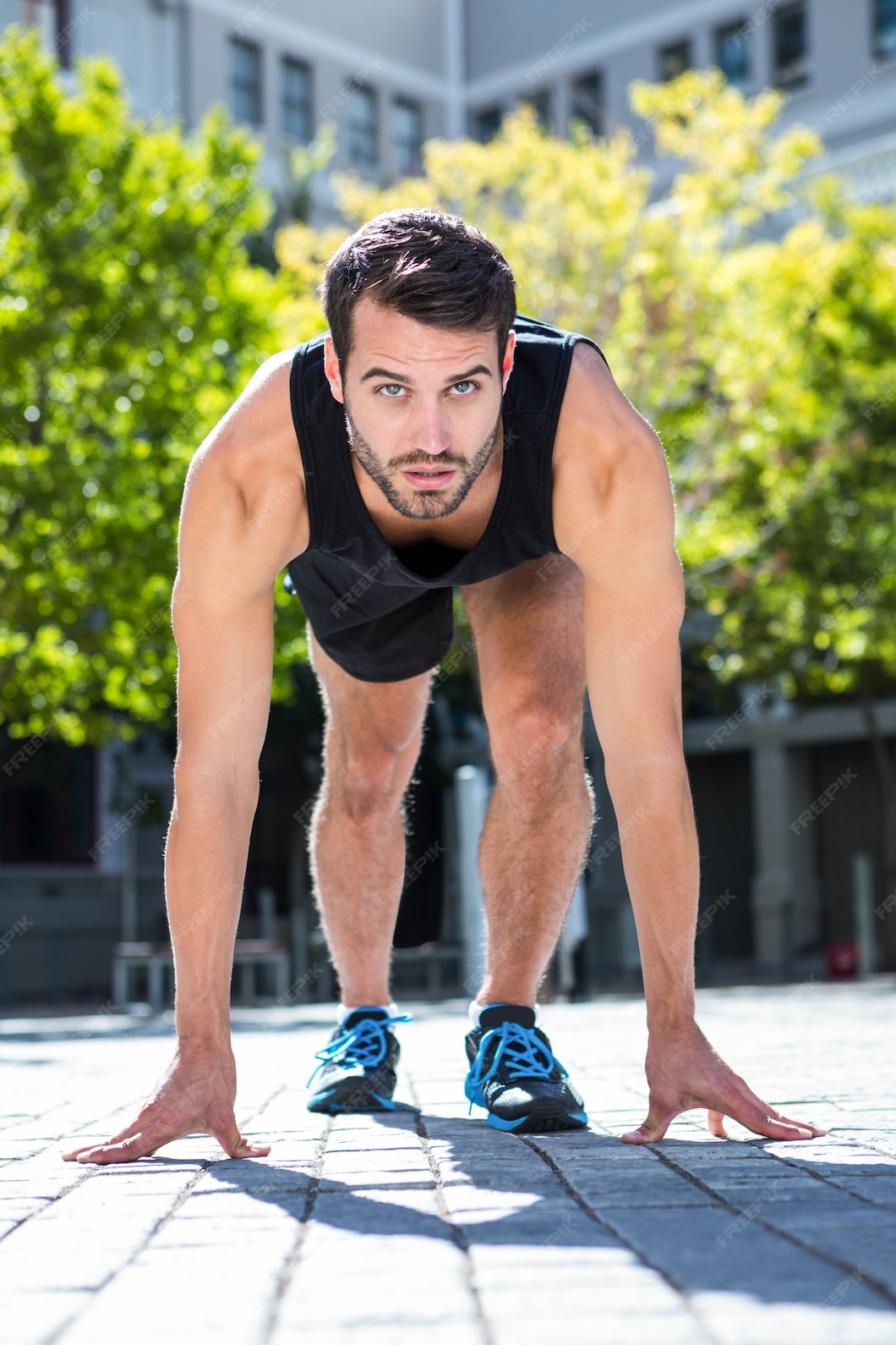 Premium Photo | Handsome athlete in running stance