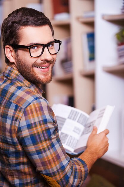 Premium Photo | Handsome bookworm. rear view of cheerful young man ...