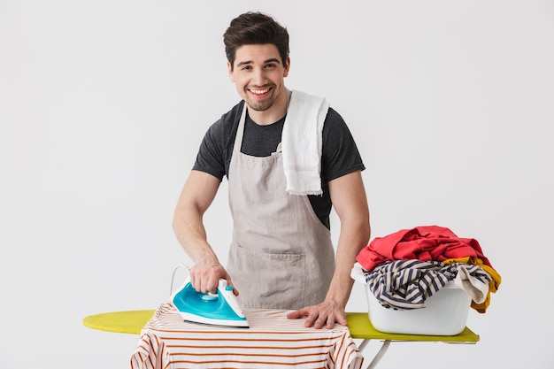 Premium Photo | Handsome brunette houseman wearing apron standing ...