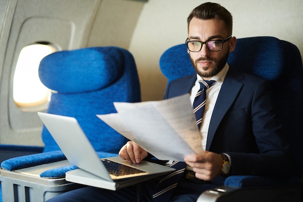 Premium Photo | Handsome business man working in plane