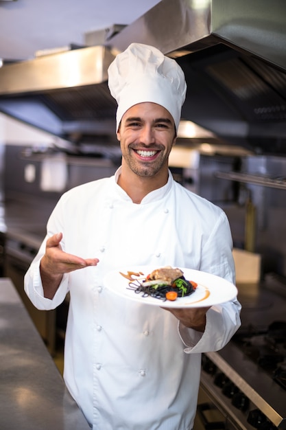 Premium Photo | Handsome chef presenting meal