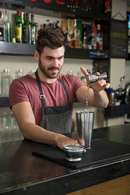 Free Photo Handsome male bartender  pouring cocktail in 
