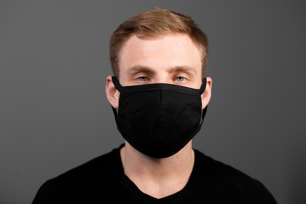 Premium Photo | Handsome man in black t-shirt wear black medical mask ...