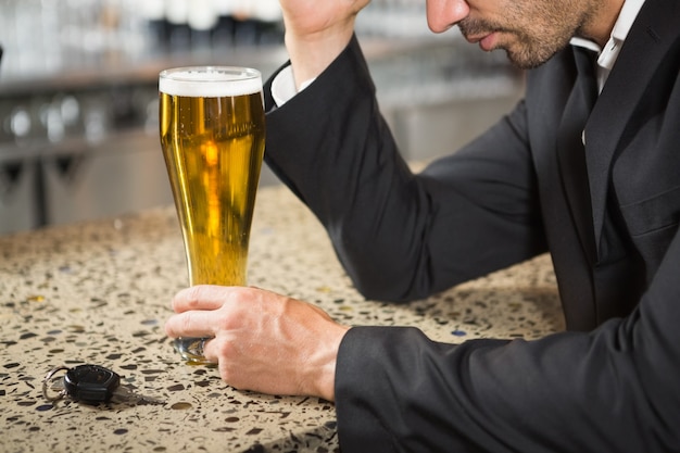 Handsome man having a beer Photo | Premium Download