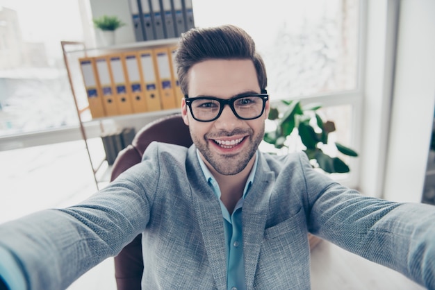 Premium Photo | Handsome man in suit taking selfie at desk