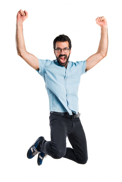 Handsome man with blue glasses jumping Photo | Free Download