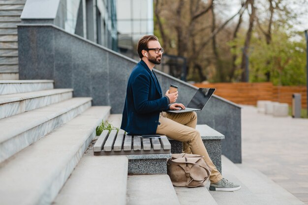 Free Photo Handsome Smiling Bearded Man In Glasses Working On Laptop