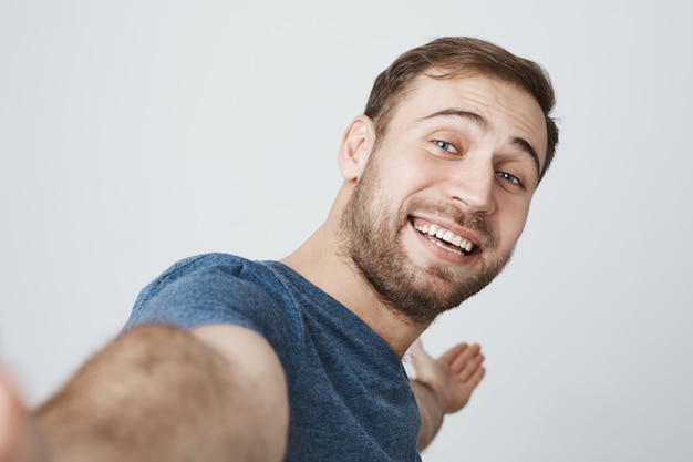 free-photo-handsome-smiling-man-taking-selfie