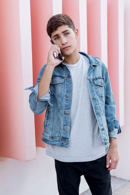 Handsome Teenage Boy Talking On Mobile Phone Sta