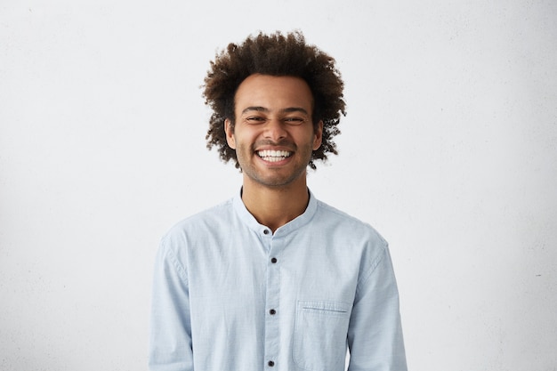 Free Photo | Handsome unshaven young dark-skinned male laughing out loud