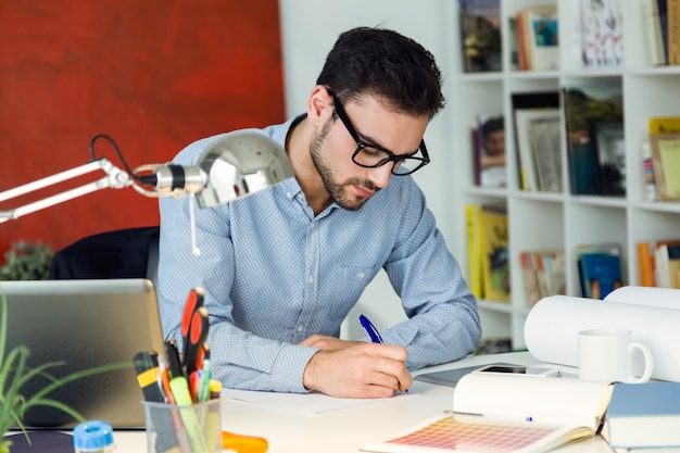 Handsome young businessman working in the office. Free Photo