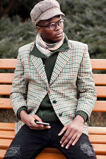 Free Photo | Handsome young male posing on a bench