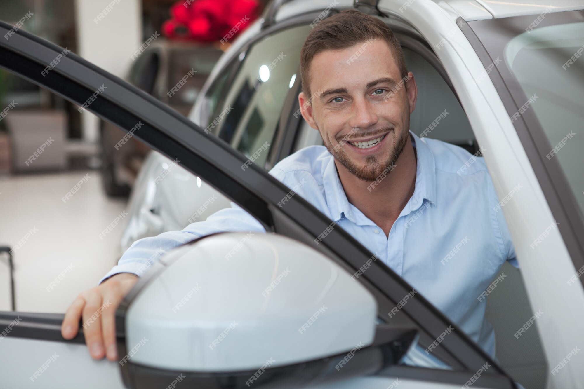 premium-photo-handsome-young-man-buying-a-new-car-at-dealership-salon