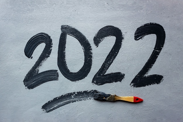 Black Ink Christmas 2022 Premium Photo | Handwritten Lettering 2022 In Black Ink On Gray Background.  Nearby Lies A Brush With Paint. New Year And Christmas Concept.