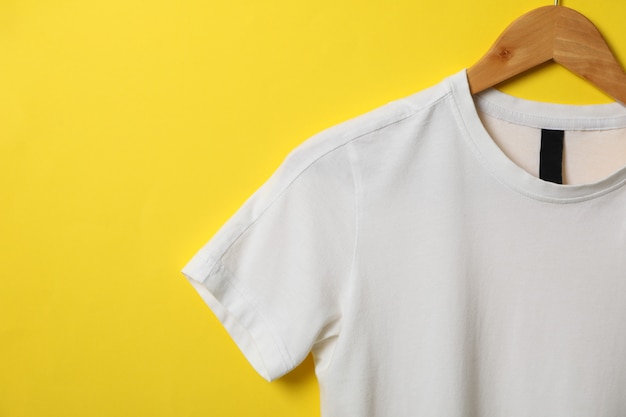Download Premium Photo Hanger With Blank White T Shirt On Yellow Yellowimages Mockups