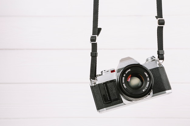 Free Photo | Hanging camera in front of white background