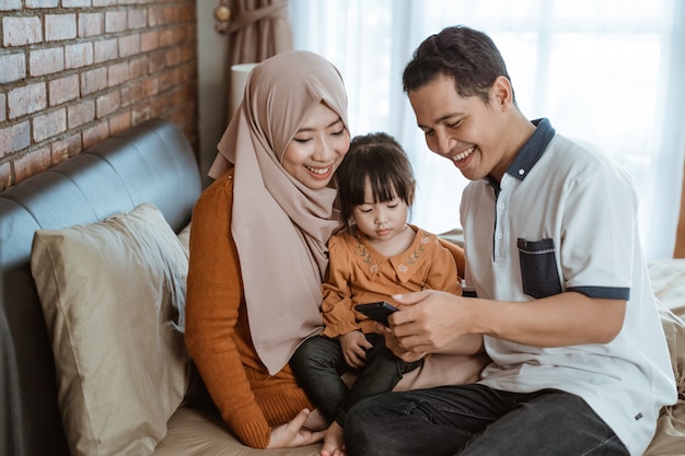 Premium Photo | Happiness of a muslim family together when using a ...