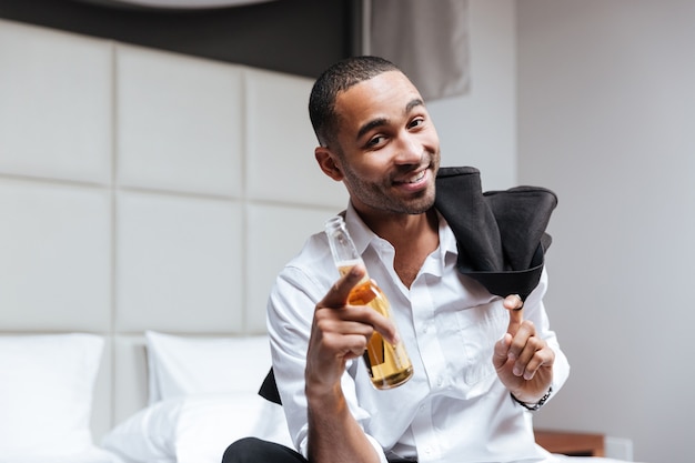 Premium Photo Happy African Man In Shirt With Beer In Hand Looking At
