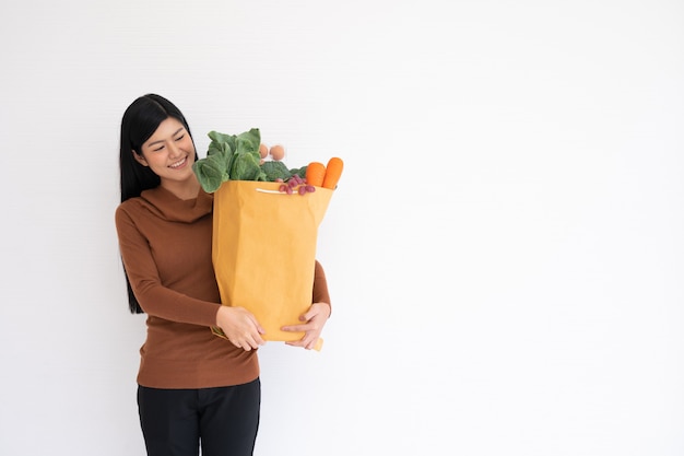 Premium Photo Happy Asian Woman Is Smiling And Carries A Shopping Paper Bag