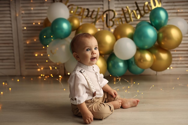 Premium Photo | Happy baby on the background of balloons with garlands ...