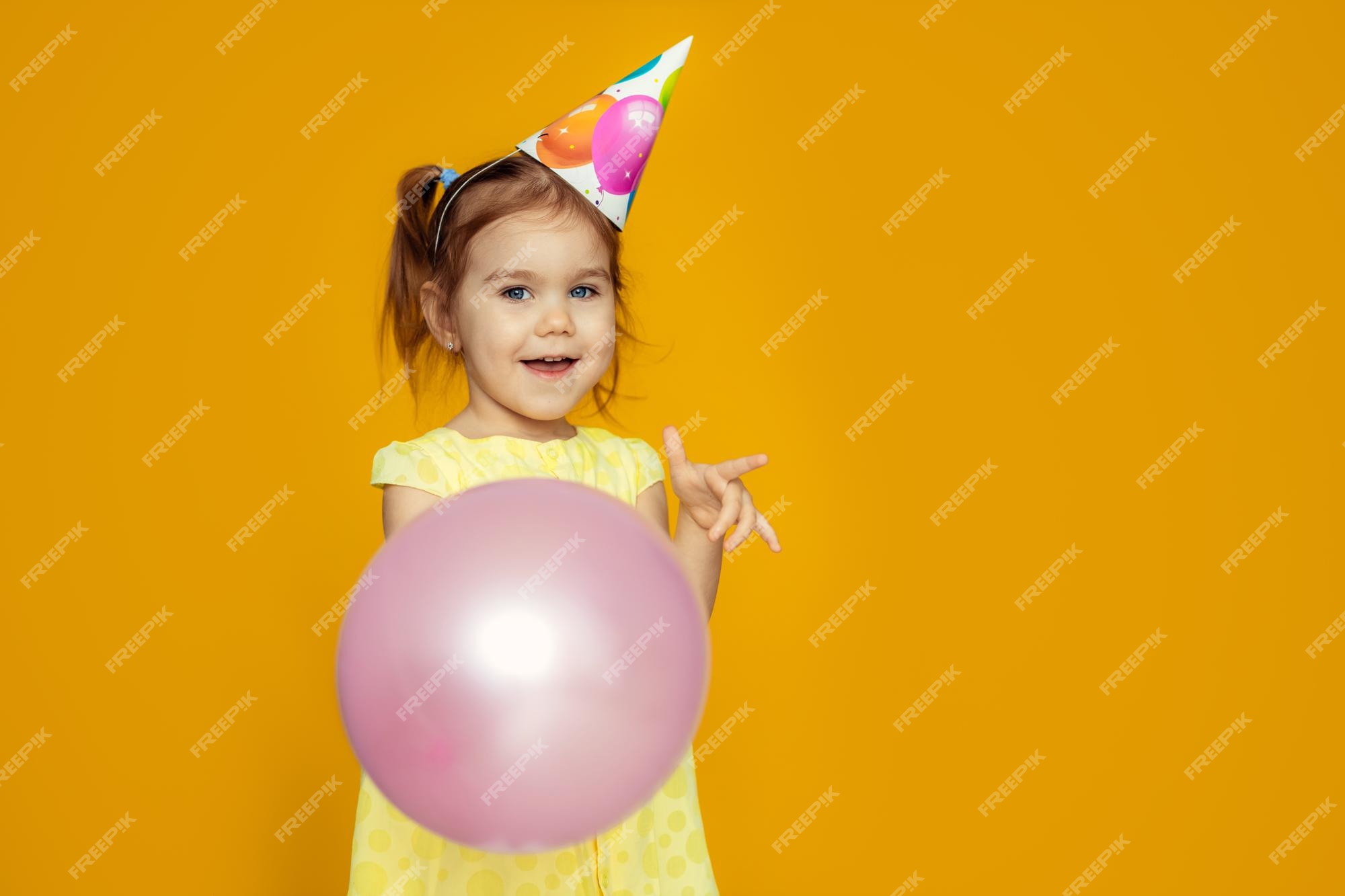 premium-photo-happy-baby-girl-in-princess-hat-at-birthday-party