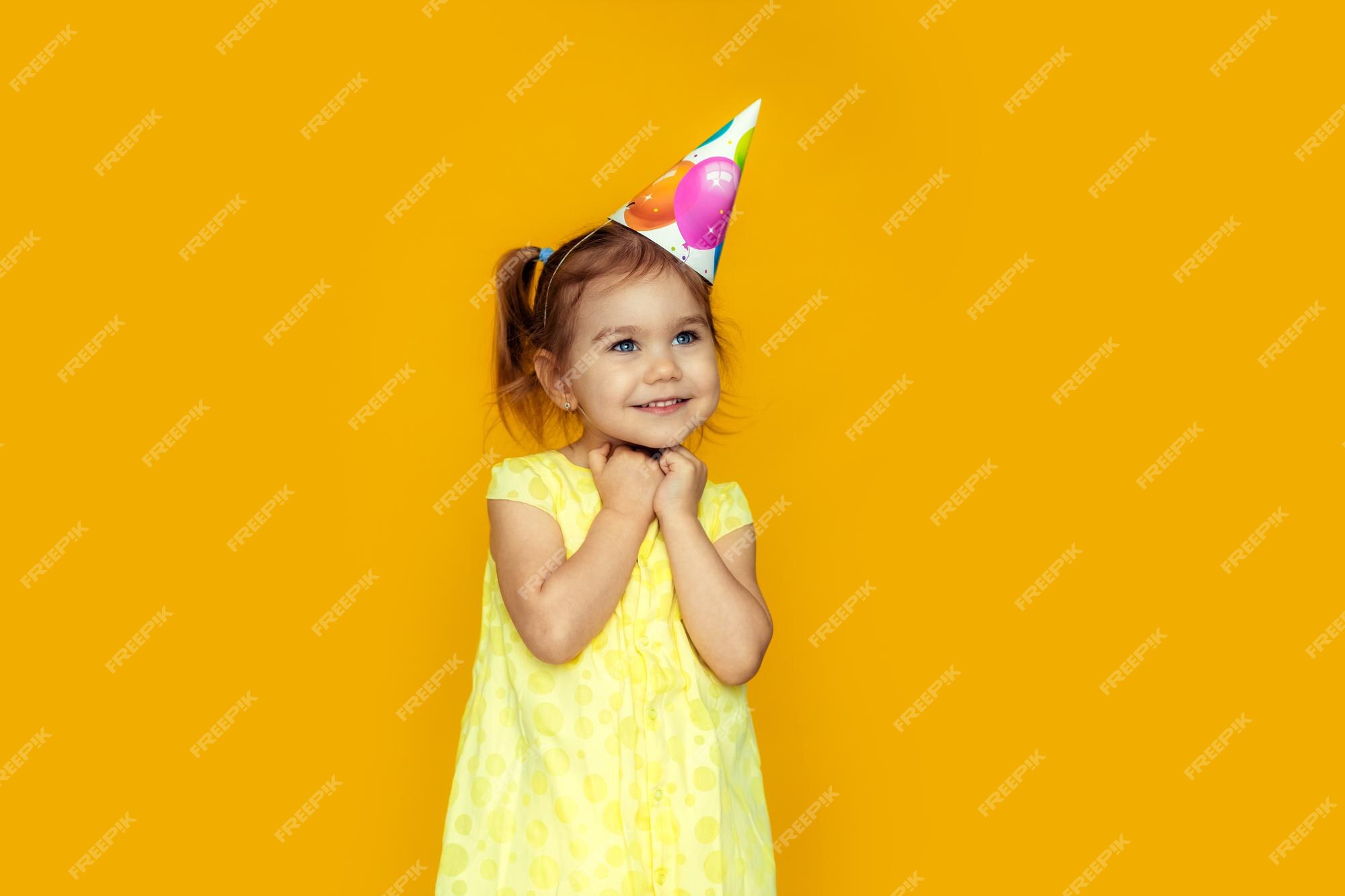 premium-photo-happy-baby-girl-in-princess-hat-at-birthday-party