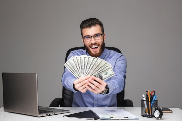 Premium Photo | Happy bearded elegant man in eyeglasses showing money ...