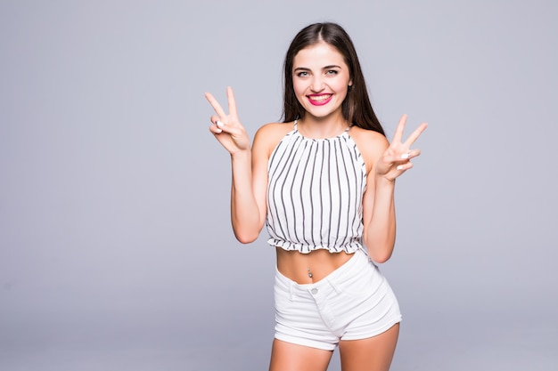 Free Photo Happy Beautiful Young Woman Showing Peace Sign With Both Hands Isolated Over Grey 4808