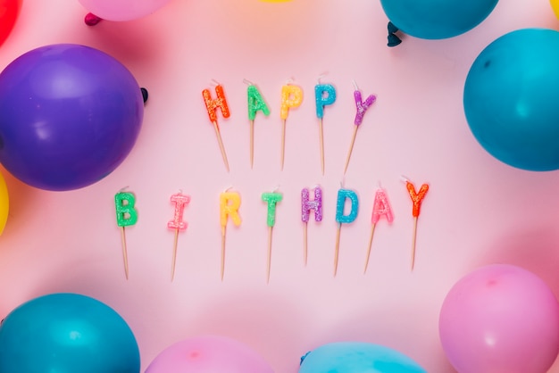 Happy birthday candles with colorful balloons on pink background | Free ...