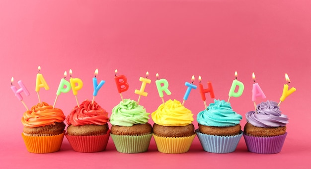 Premium Photo | Happy birthday cupcakes on pink