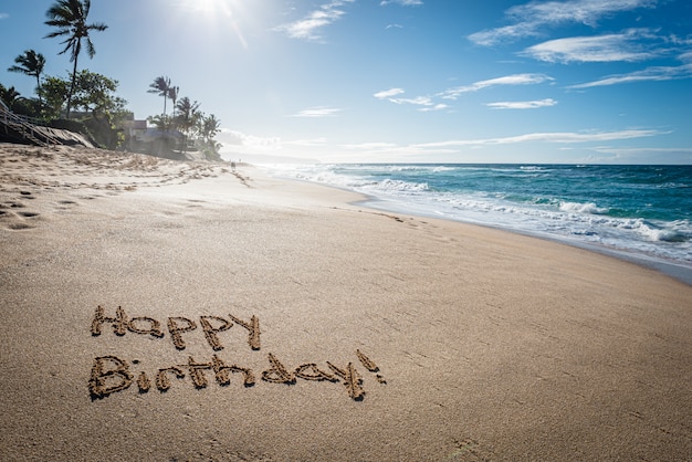 Premium Photo | Happy birthday written in the sand on sunset beach in ...