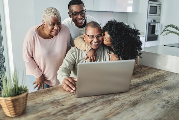 Happy black family doing video call at home - main focus on son face Premium Photo