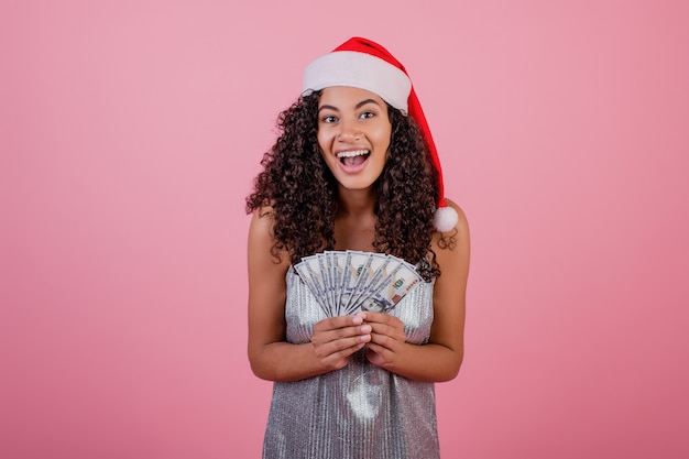 Happy Black Girl Holding One Hundred Dollar Bills Wearing Santa Hat Isolated Premium Photo