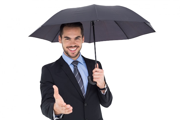 Premium Photo | Happy businessman under umbrella offering handshake