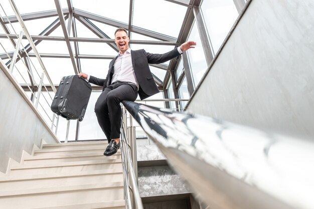 premium-photo-happy-businessman-wearing-formal-suit-sliding-on-stairs