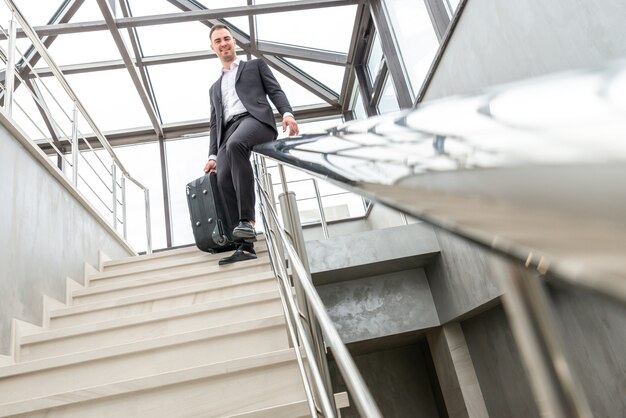 premium-photo-happy-businessman-wearing-formal-suit-sliding-on-stairs