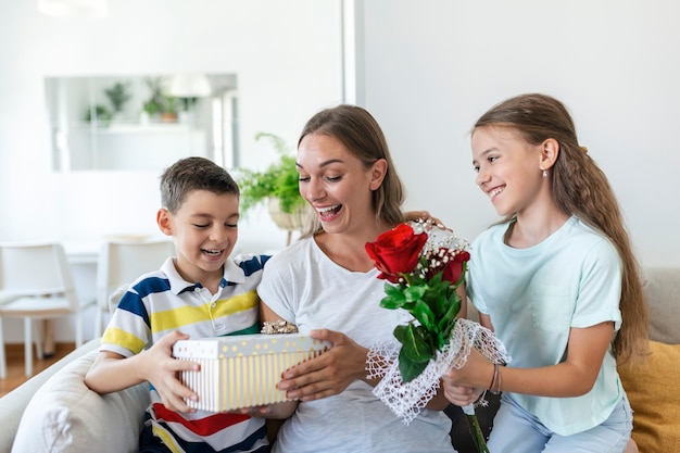 Premium Photo | Happy children giving gift an flowers to mother. happy ...