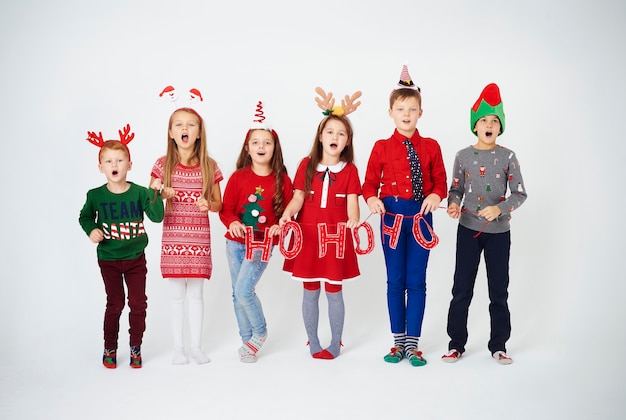 Happy children singing christmassy carols Free Photo