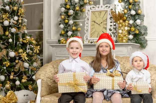 Premium Photo Happy Children With Christmas Presents Kids Holding Gifts Boxs