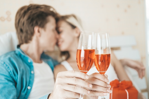 Happy couple drinking wine in the bedroom Free Photo