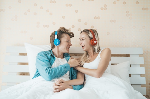 Happy Couple Listening Song In The Morning At Bedroom Photo