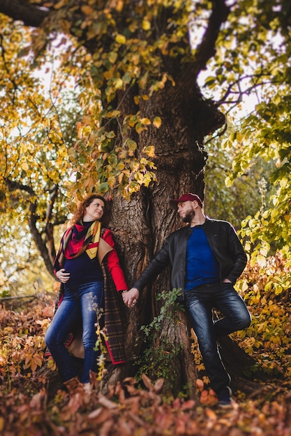 Premium Photo Happy Couple In Love Embraces And Has Fun Outside In The Nature Background Woman Is Pregnant Happy New Parents