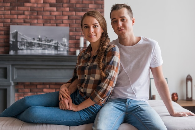 Happy couple in love sitting together at home Free Photo