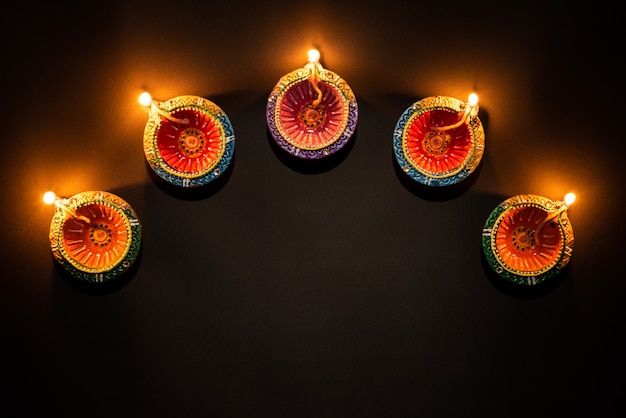 Premium Photo | Happy diwali - clay diya lamps lit hindu festival of ...