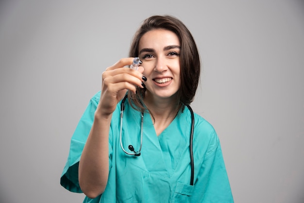 Free Photo | Happy doctor in uniform posing with syringe ...