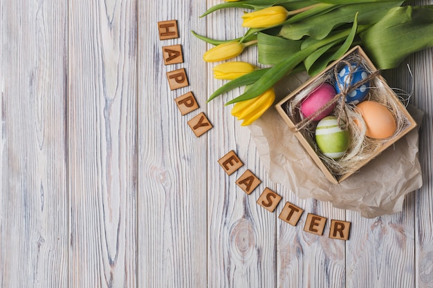 Happy easter writing near tulips and eggs Photo | Free ...